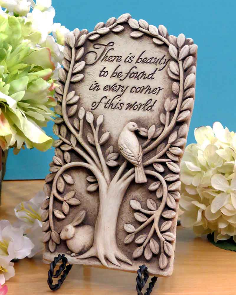 Hidden Beauty plaque on a black easel beside white and green hydrangeas